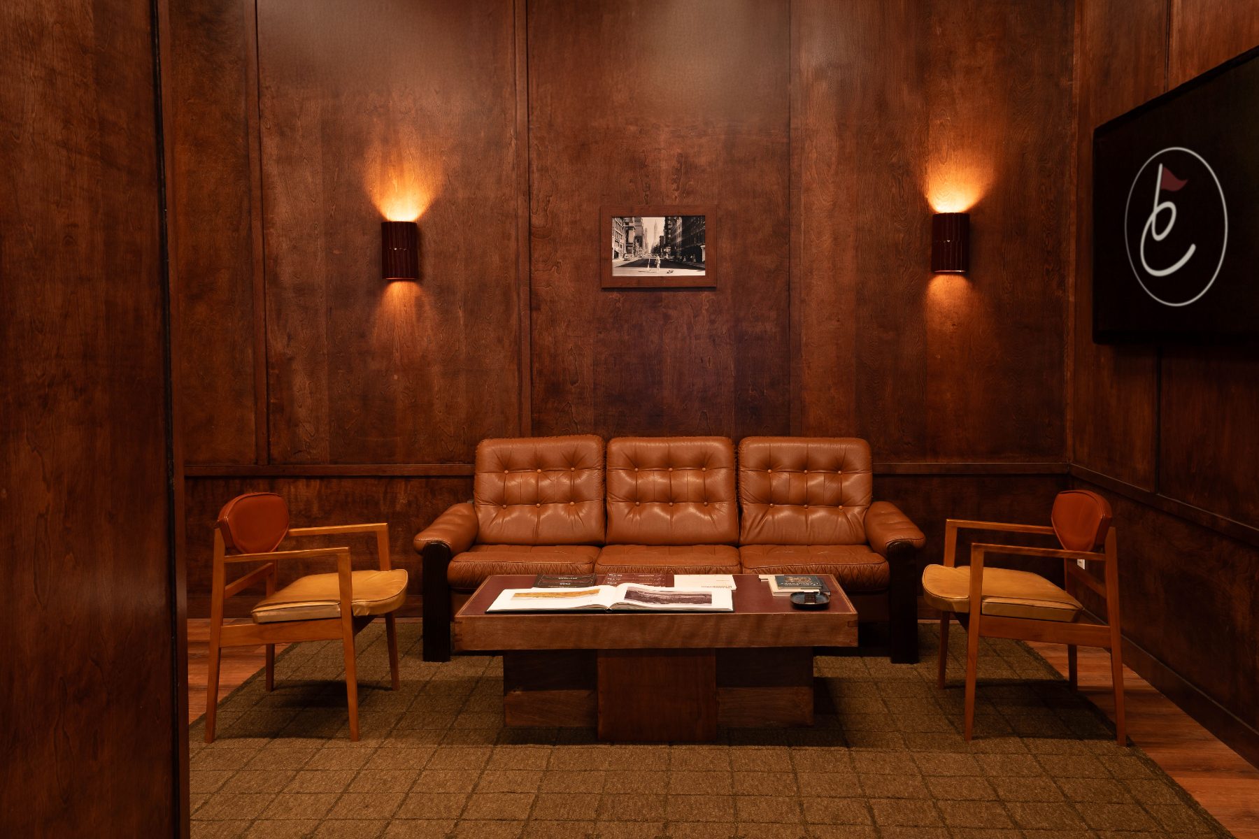 clubhouse lounge, leather sofa and wood paneled walls